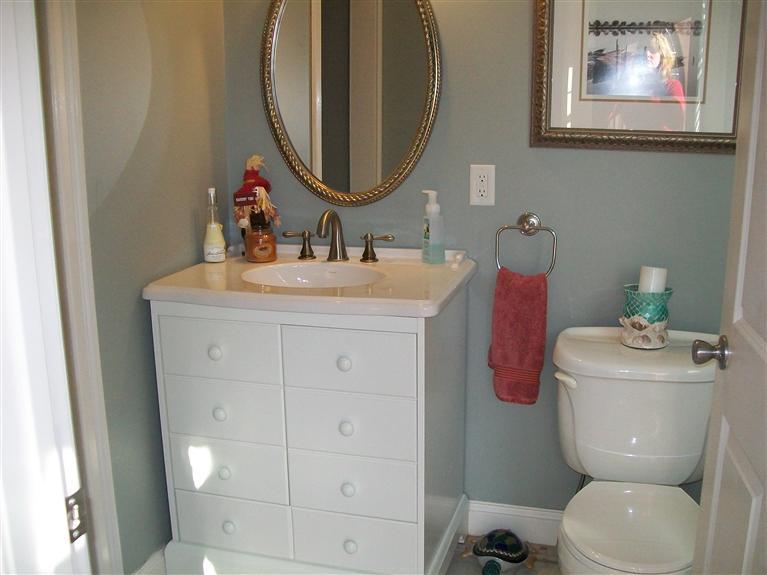 71 Meadowbrook Road Mashpee, MA 02649 - Photo 5 of 14 a bathroom with a toilet sink and mirror