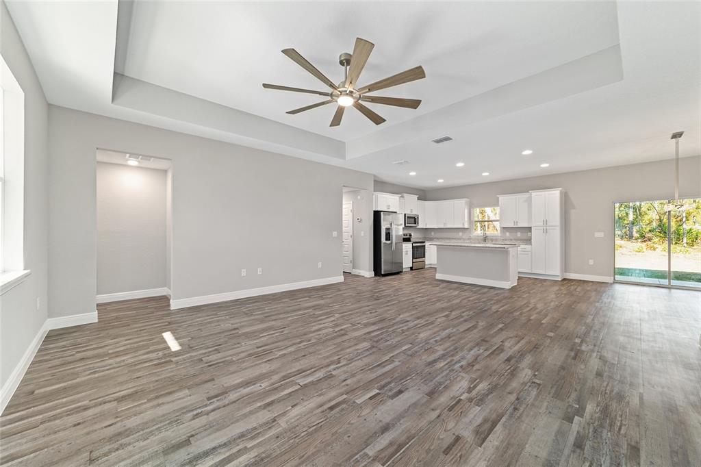 13359 Southwest 80th Street Dunnellon, FL 34432 - Photo 11 of 64 a view of a livingroom with a hardwood floor and a ceiling fan