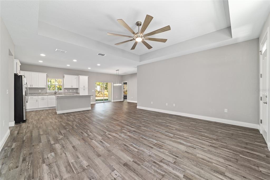 13359 Southwest 80th Street Dunnellon, FL 34432 - Photo 13 of 64 a view of a livingroom with a hardwood floor and a ceiling fan