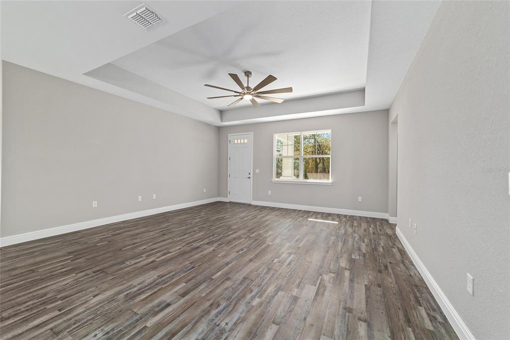13359 Southwest 80th Street Dunnellon, FL 34432 - Photo 15 of 64 an empty room with wooden floor and windows