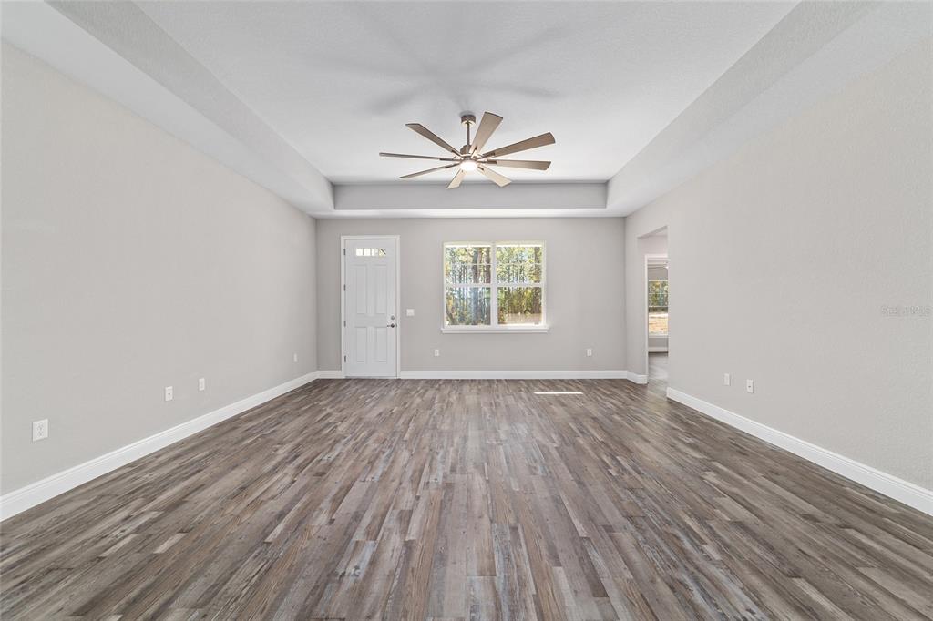 13359 Southwest 80th Street Dunnellon, FL 34432 - Photo 16 of 64 wooden floor in an empty room with a window