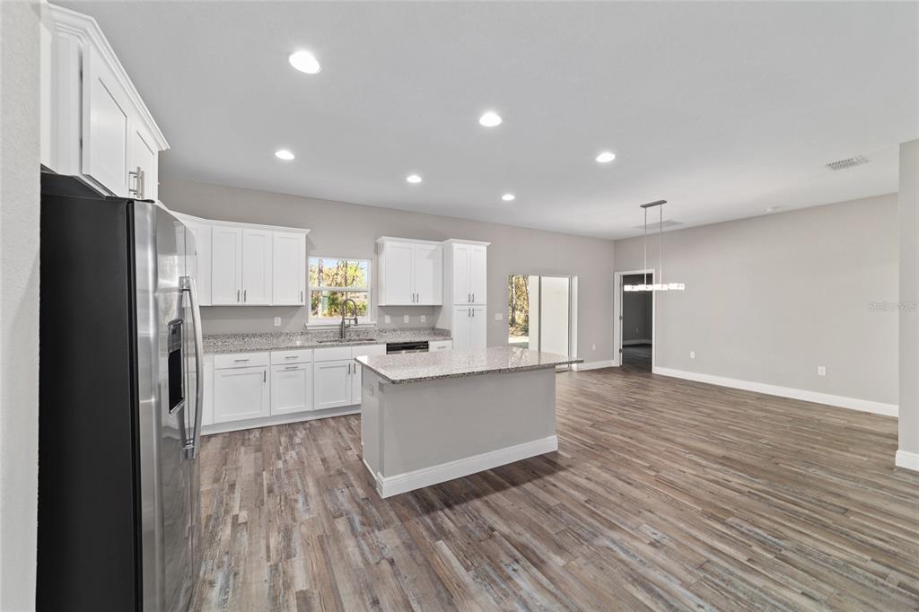 13359 Southwest 80th Street Dunnellon, FL 34432 - Photo 28 of 64 a kitchen with stainless steel appliances a refrigerator sink and cabinets