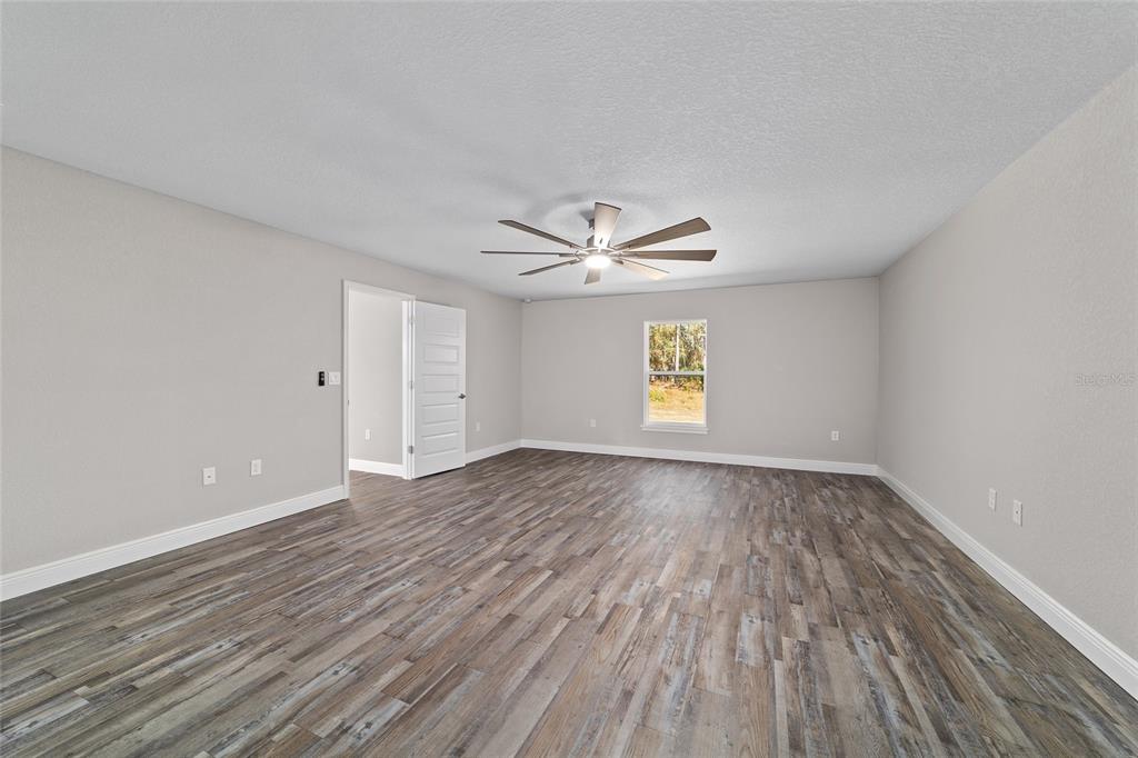13359 Southwest 80th Street Dunnellon, FL 34432 - Photo 35 of 64 wooden floor in an empty room with a window