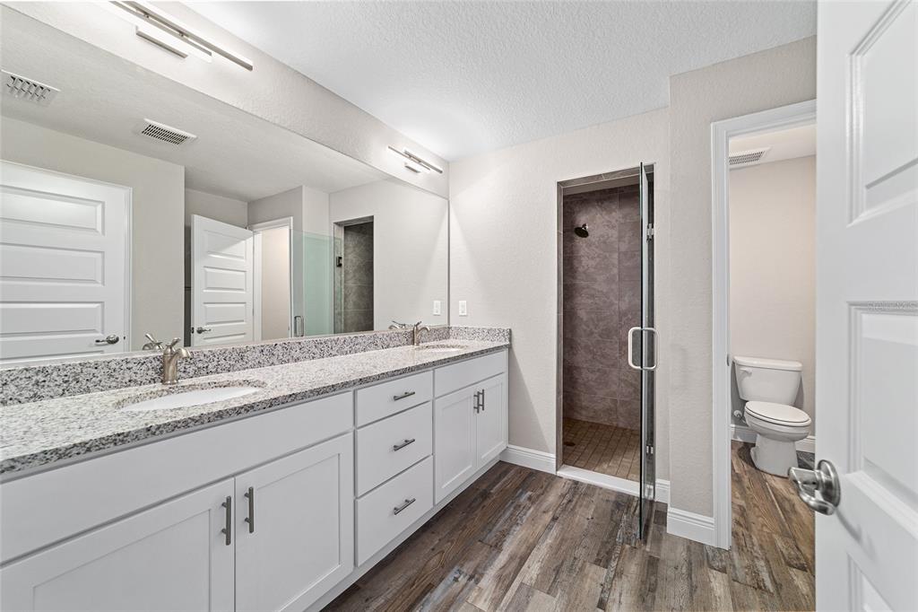 13359 Southwest 80th Street Dunnellon, FL 34432 - Photo 36 of 64 a spacious bathroom with a granite countertop sink mirror and toilet