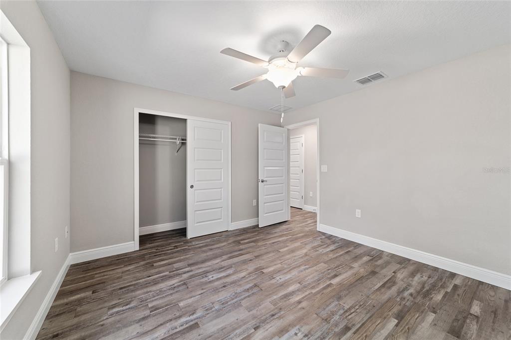 13359 Southwest 80th Street Dunnellon, FL 34432 - Photo 41 of 64 an empty room with wooden floor and closet area