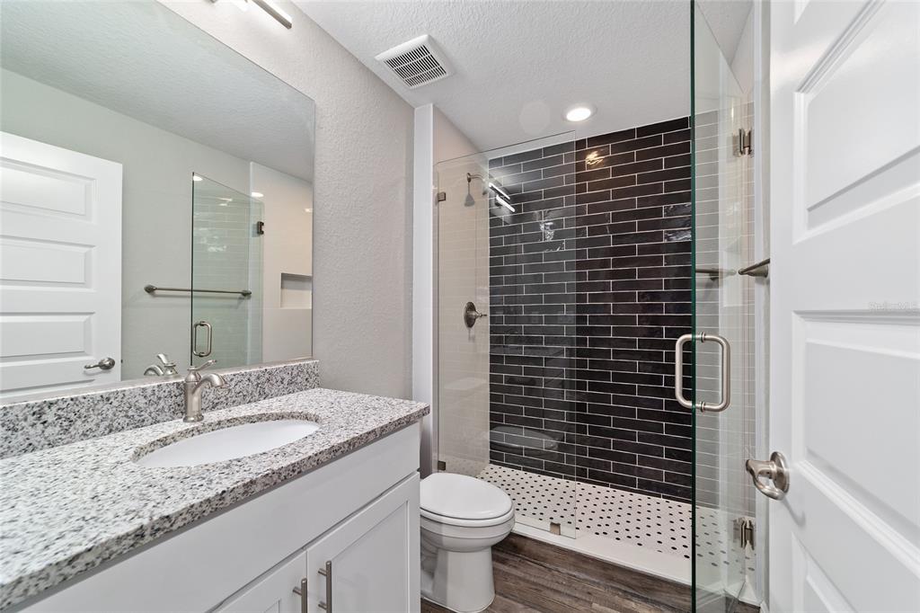 13359 Southwest 80th Street Dunnellon, FL 34432 - Photo 42 of 64 a bathroom with a granite countertop sink toilet and shower