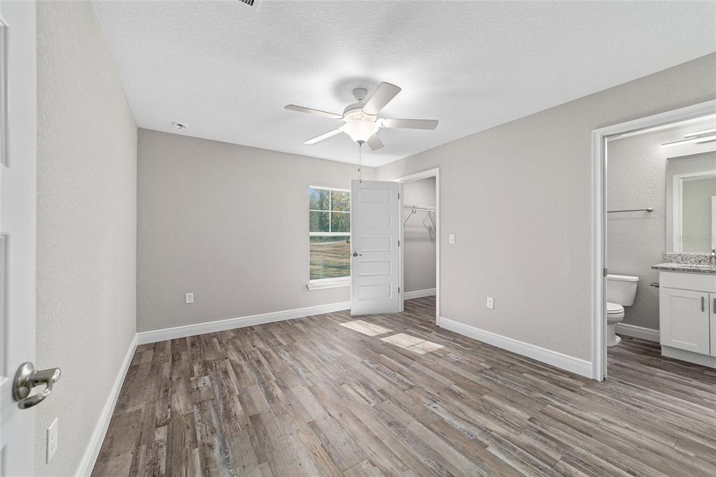 13359 Southwest 80th Street Dunnellon, FL 34432 - Photo 49 of 64 wooden floor in an empty room with a window
