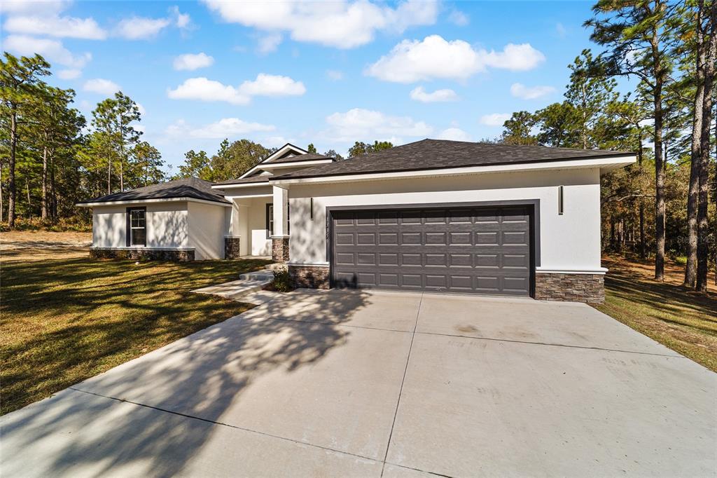 13359 Southwest 80th Street Dunnellon, FL 34432 - Photo 7 of 64 a view of house with backyard and trees in the background