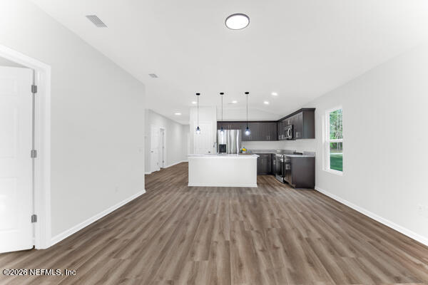 407 Rustic Road Satsuma, FL 32189 - Photo 12 of 55 a large white kitchen with kitchen island a sink dishwasher a stove and a refrigerator with wooden floor