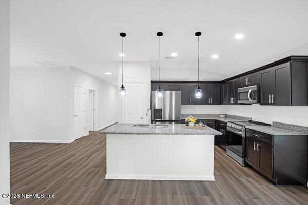 407 Rustic Road Satsuma, FL 32189 - Photo 15 of 55 a kitchen with stainless steel appliances granite countertop a sink a stove and a wooden floors
