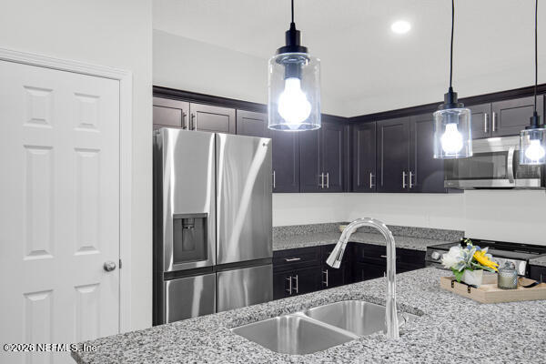 407 Rustic Road Satsuma, FL 32189 - Photo 16 of 55 a kitchen with stainless steel appliances kitchen island a refrigerator and a sink