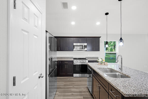 407 Rustic Road Satsuma, FL 32189 - Photo 17 of 55 a kitchen with stainless steel appliances granite countertop a sink stove and refrigerator