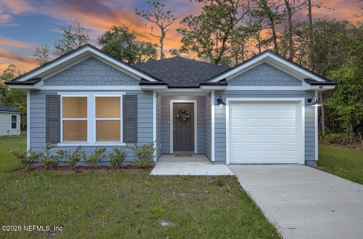 407 Rustic Road Satsuma, FL 32189 - Photo 2 of 55 a front view of a house with a garden and yard