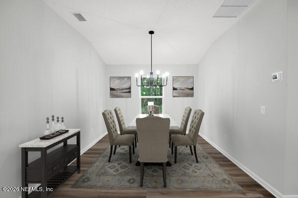 407 Rustic Road Satsuma, FL 32189 - Photo 22 of 55 a dining room with furniture a rug and a chandelier