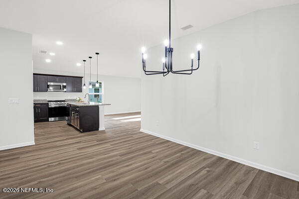 407 Rustic Road Satsuma, FL 32189 - Photo 23 of 55 a view of a kitchen with a sink cabinets and wooden floor