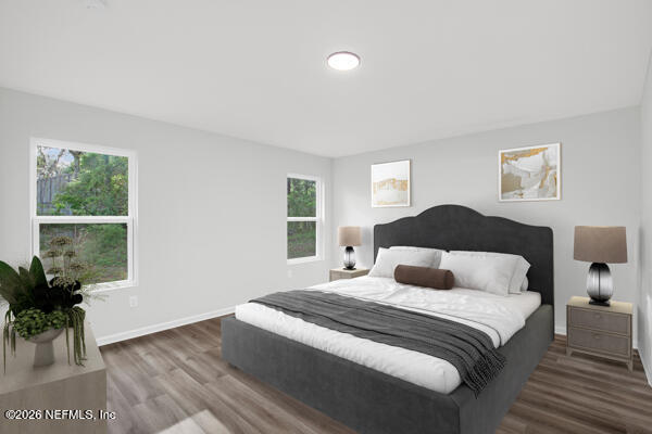 407 Rustic Road Satsuma, FL 32189 - Photo 25 of 55 a bedroom with a bed and a potted plant