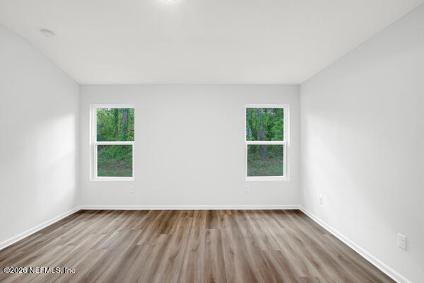 407 Rustic Road Satsuma, FL 32189 - Photo 27 of 55 an empty room with wooden floor and windows