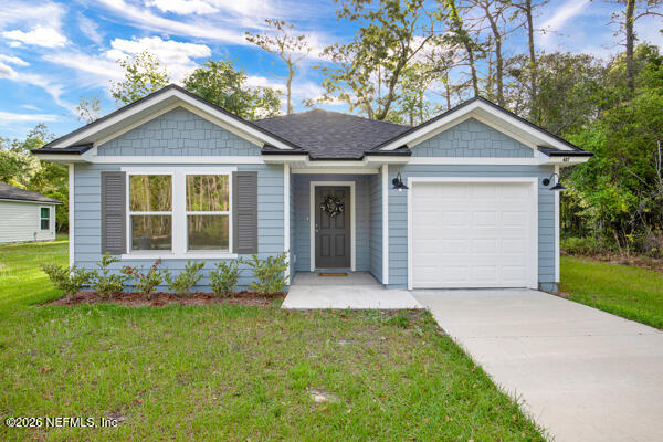 407 Rustic Road Satsuma, FL 32189 - Photo 3 of 55 a front view of a house with garden