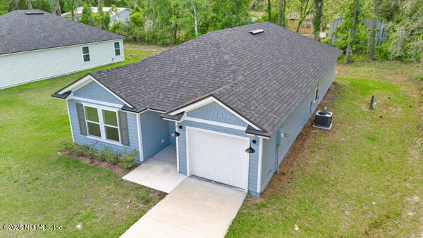 407 Rustic Road Satsuma, FL 32189 - Photo 44 of 55 a aerial view of a house next to a yard with big trees
