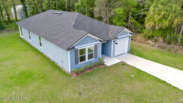 407 Rustic Road Satsuma, FL 32189 - Photo 45 of 55 a aerial view of a house next to a big yard and large trees