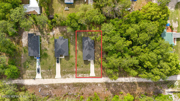 407 Rustic Road Satsuma, FL 32189 - Photo 55 of 55 a view of a brick house with large windows and a yard