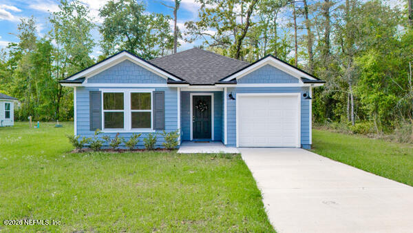 407 Rustic Road Satsuma, FL 32189 - Photo 6 of 55 a view of a yard in front of a house with a large tree