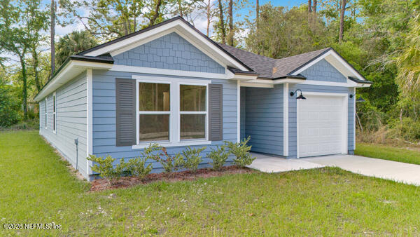 407 Rustic Road Satsuma, FL 32189 - Photo 8 of 55 a view of a house with brick walls and a yard with plants