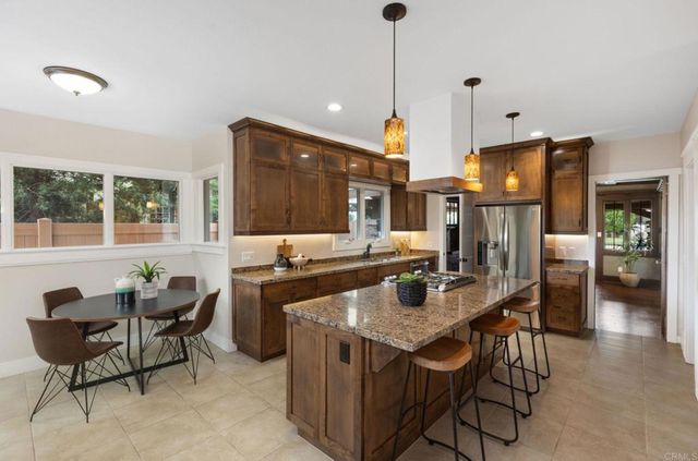 a dining table chairs and a kitchen view