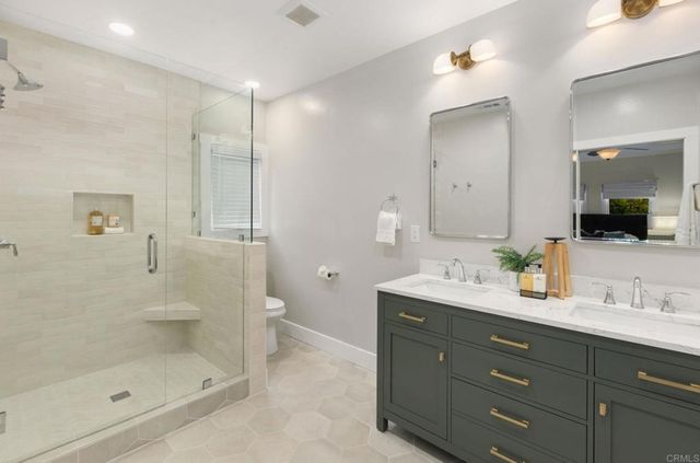 a bathroom with a shower sink and mirror