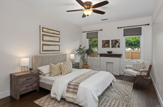 a bedroom with a bed a couch and dresser