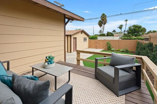 a roof deck with table and chairs