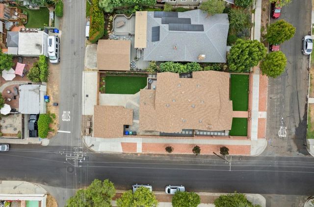 an aerial view of a house with a street