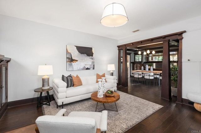 a living room with furniture and a chandelier