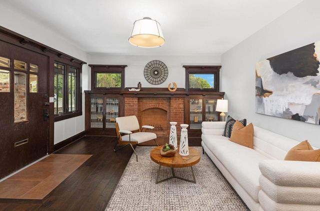 a living room with furniture a fireplace and a window