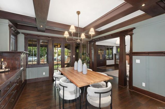 a view of a dining room with furniture wooden floor and chandelier