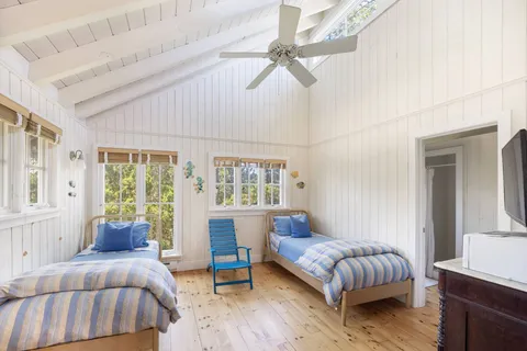 a bedroom with a bed and a chair