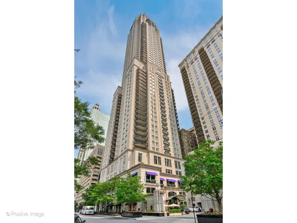 a view of a tall building next to a road