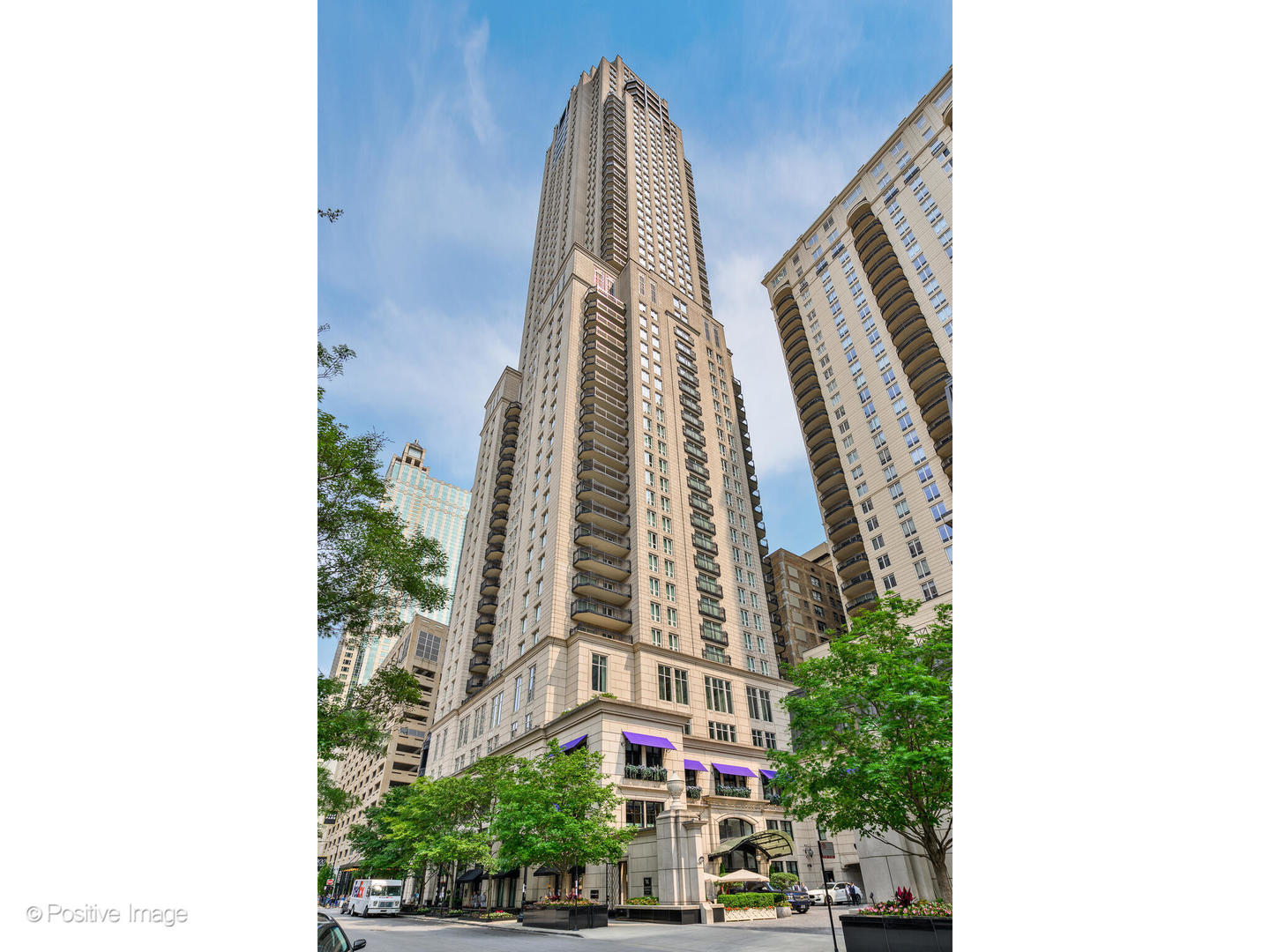 a view of a tall building next to a road