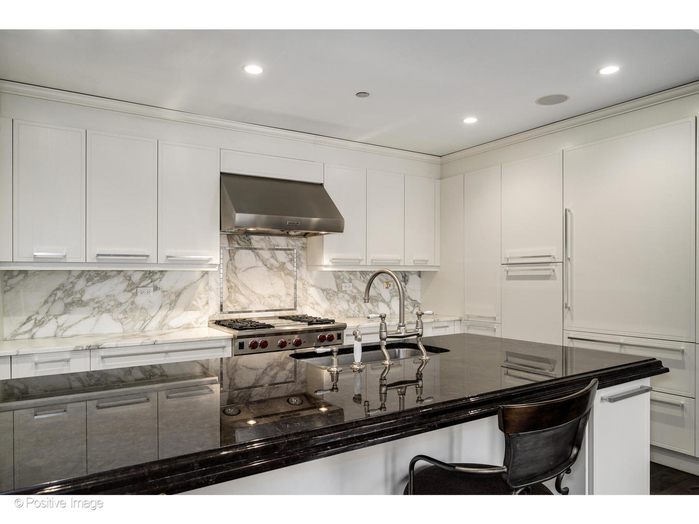 11 East Walton Street, Unit 3201 Chicago, IL 60611 - Photo 11 of 42 a kitchen with kitchen island a sink stove and cabinets