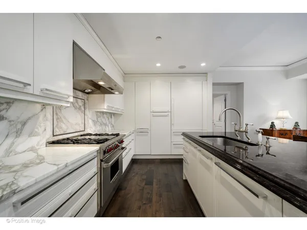 a kitchen with granite countertop stainless steel appliances and sink