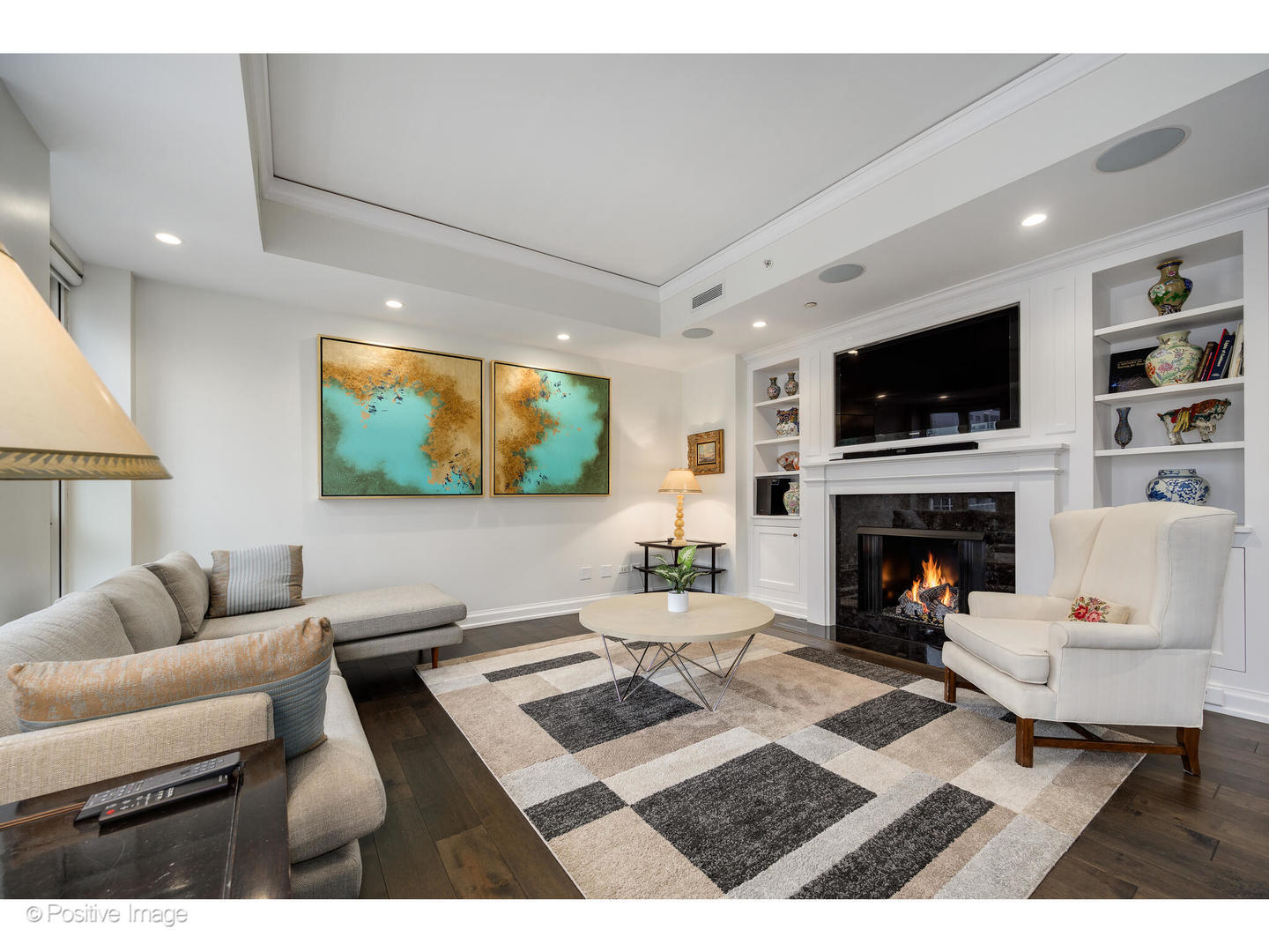 11 East Walton Street, Unit 3201 Chicago, IL 60611 - Photo 16 of 42 a living room with furniture a flat screen tv and a fireplace