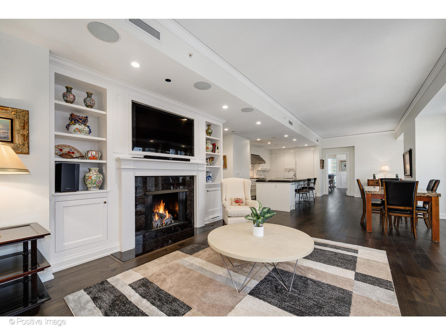 11 East Walton Street, Unit 3201 Chicago, IL 60611 - Photo 18 of 42 a living room with furniture a flat screen tv and a fireplace
