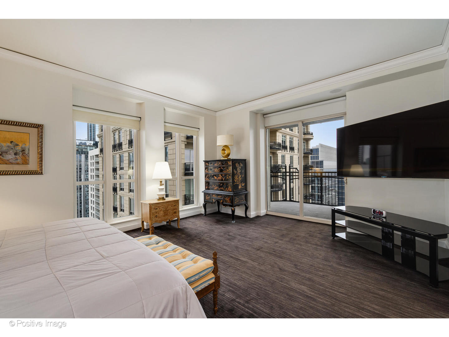 11 East Walton Street, Unit 3201 Chicago, IL 60611 - Photo 22 of 42 a bedroom with a bed and a flat tv screen on wall