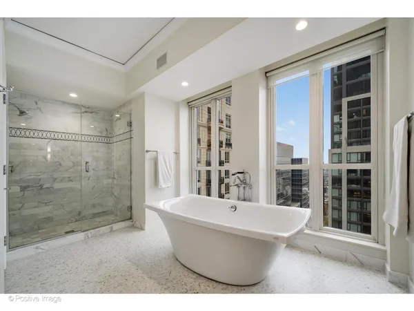 a bathroom with a bathtub and shower