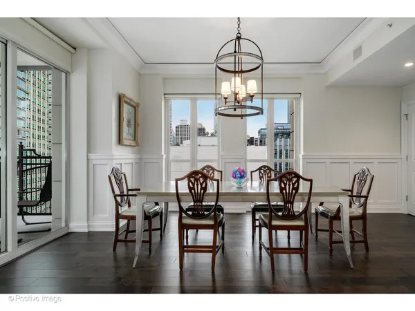a view of a dining room with furniture and chandelier
