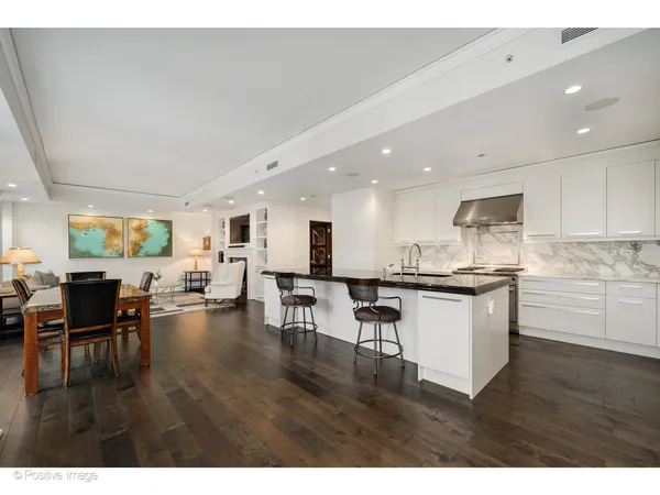a open kitchen with white cabinets and stainless steel appliances