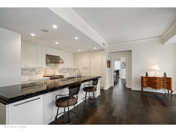 a kitchen with stainless steel appliances kitchen island granite countertop a sink and cabinets