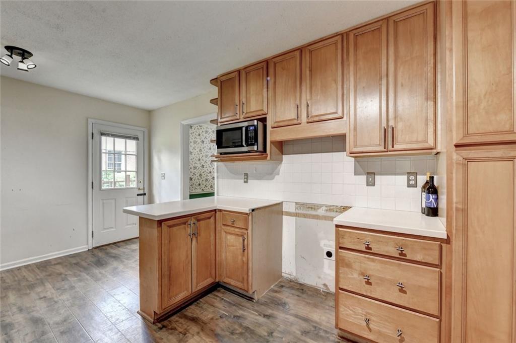 1577 Harbour Oaks Road Tucker, GA 30084 - Photo 26 of 58 a kitchen with a sink cabinets stainless steel appliances and a window