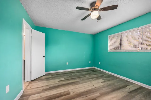 a view of a room with a ceiling fan and a window