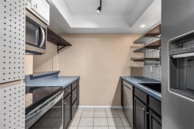 a kitchen with stainless steel appliances a stove and a microwave
